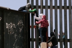 punjabis crossing US mexico border, entering US via mexico, video clip shows punjabi women children crossing border fence into u s, Mexico border